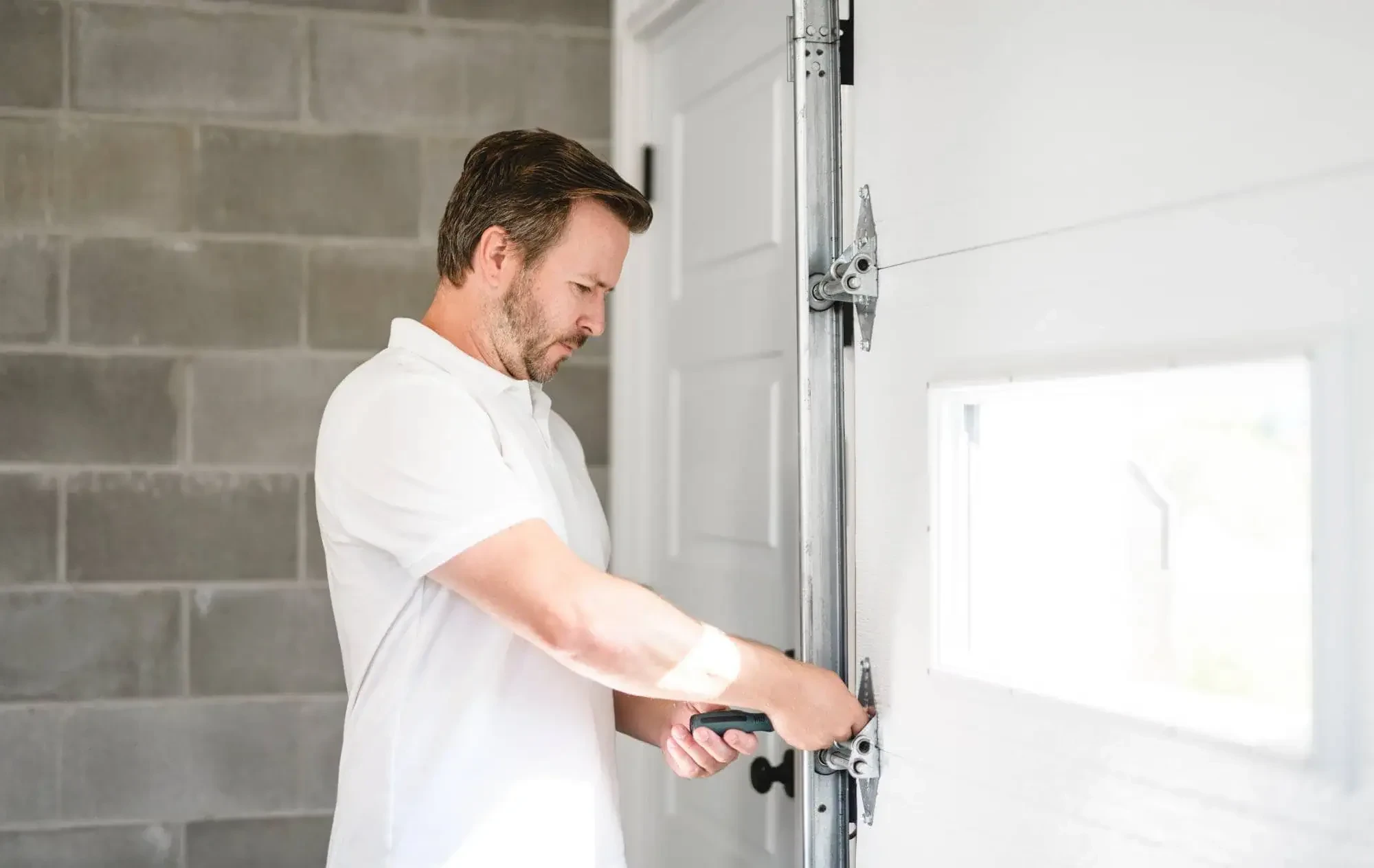 Man Fixing Garage Door Nassau County New York